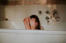 feet wet bathtub propped ledge offset child