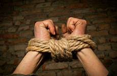 tied rope hands man stock wall against brick tying bond tie royalty human warrior prisoner policeman trafficking accused people know