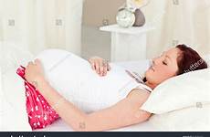 pregnant shutterstock woman belly lying portrait happy touching bed her stock