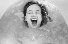 girl playing young bathtub stocksy