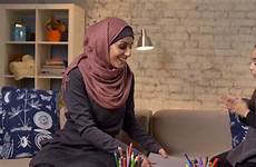 muslim mother hijab daughter her young takes hands fps enthusiastically laughs claps book