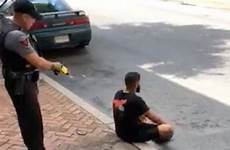 police man gun taser stun officer firing video sitting