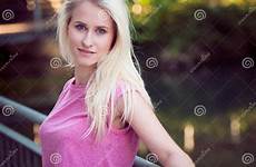 leaning fence shadow blonde woman young beautiful preview