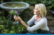gardener potted holding working flowers female stock while