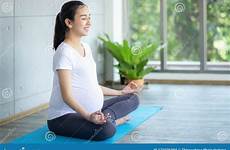 pregnant yoga woman mat practicing doing asian health living room good women