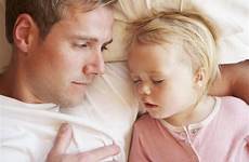 sleeping bed daughter father stock cuddle bedtime young girl
