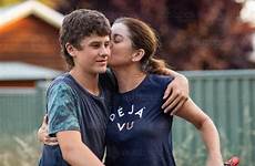 son kissing mother cheek austockphoto teenaged
