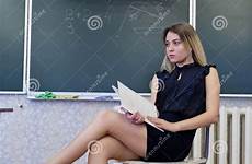 legs teacher strict chair blonde young her crossing sits lady preview
