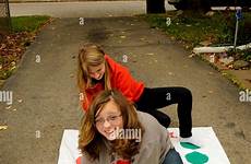 twister girls playing teen game floor pre alamy