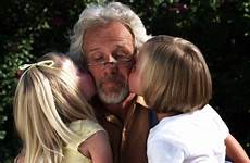 grandfather kissing granddaughters their