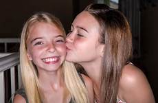 friend daughter kiss gives her
