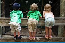 over fence looking children cousins kids three stock look zoo cage dreamstime into little