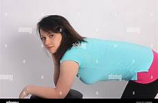 bent over young brunette stool alamy against lovely shirt blue