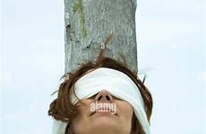 blindfolded woman leaning against tree trunk women stock blind alamy folded shopping cart