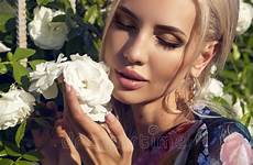 hair beautiful blond posing rose garden woman dress glamour bush colorful fashion model stock