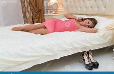 young petite bed laying female elegant sleeping stock