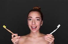 holding woman toothbrushes close