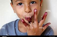 licking fingers boy his alamy