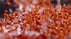 Macro Frame of White and Orange Plastic Granules The Polymer Composite is Poured Into a Tank for