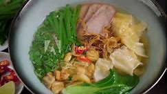 Hot Chinese wonton noodle soup. Dumplings are known by various names worldwide such as gyoza, wonton, mandu, xiaolongbao, and jiaozi.