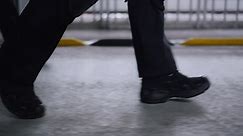 Free stock video - Men in black shoes walking on road