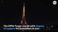 Paris' Eiffel Tower lights up with slogans of support for protesters in Iran