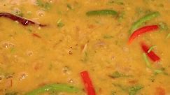 Adding boiling dal lentil into bagar tadka with deep fry tomato onion garlic cumin red dry chilli spice stair cooking dal ghotni whisk