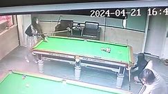 Woman chips white ball onto friend's head while trying to break