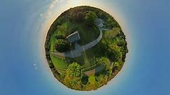 Tiny Planet Drone 360 degree view Panning from the Joseph Smith Log Cabin and frame house and visitors center sacred grove over to the Palmyra Mormon temple miniature