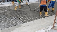 Details of construction site. worker pouring concrete with automatic pump, construction worker pouring cement or concrete with pump tube. Reinforced steel bars and rods