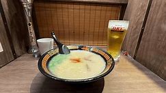 TOKYO, JAPAN - APRIL 20, 2024: Fresh ramen served at Ichiran in Tokyo, Japan. Steaming hot Japanese ramen, a traditional noodle soup served with cold beer. Solo dining in individual booth.