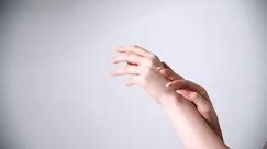 Close-up view of woman dancing using only her hands with soft touch against grey background. Real time handheld video. Soft focus. Self expression theme.