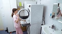 Teenager girl doing laundry at her home