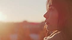 Profile of a Woman at Sunset with Lens Flare