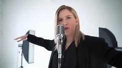 Blond female singer singing song in a studio