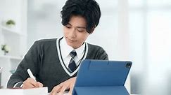 Young Asian schoolboy studying with a tablet PC. Online class. e-learning.