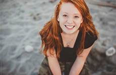 redhead girl beach teenage happy portrait sitting stocksy