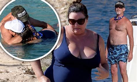 Busty wife does it again. Pierce Brosnan can barely keep his hands off wife of 16 ...