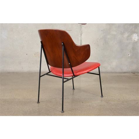 Success spawned variations—there's a penguin lounge, dining chair, and rocker—and then knockoffs; Kofod-Larsen Penguin Chair | Chairish