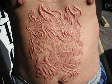 Scarification scarification, the art of carving decorative scars into the skin, is an ancient practice on the continent of africa that is now fading from use. Scarification - Body Mods-r-us