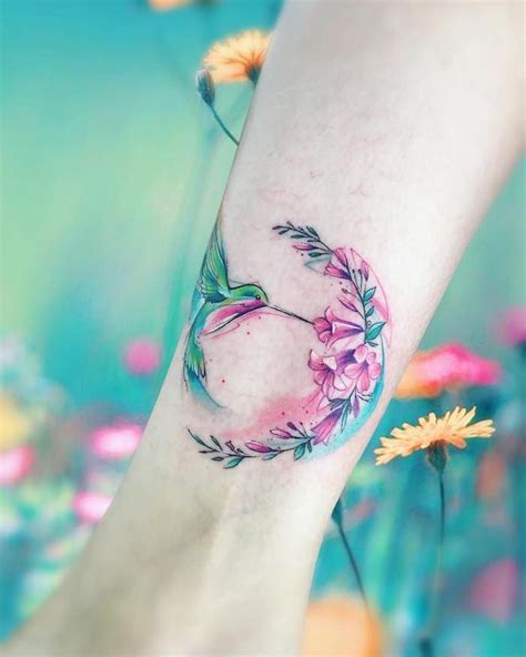 This tattoo consists of a hummingbird flapping its wings and includes different colors like blue, pink, orange, black, and purple. Pin on DECORATING IDEAS