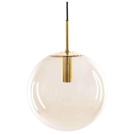 Glass globe shade rope pendant light with antique brass socket. One of Ten Limburg Globe Pendant Lights Brass and Smoked Glass For Sale at 1stdibs