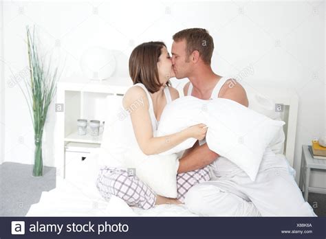 Share the best gifs now >>> Romantic Couple Kissing In Bed High Resolution Stock ...