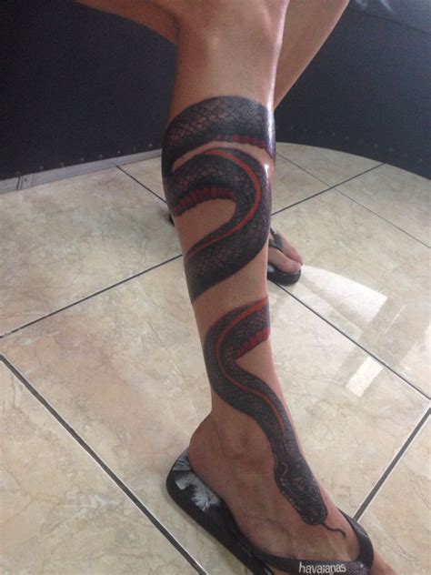 Dagger skeleton snake tattoo on leg. leg black Snake red belly tattoo done by Agung Dana Goerat ...