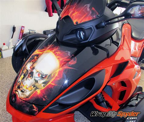 The vehicle has a single rear drive wheel and two wheels in front for steering, similar in layout to a modern snowmobile. ATV skull wrap Archives | WrapMySpyder.com