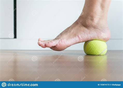 Repeat 3 times, 3 times per day. Women Massage With Tennis Ball To Her Foot In Bedroom,Feet ...