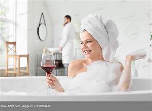 Beautiful Young Woman Drinking Wine While Taking Bath Stock