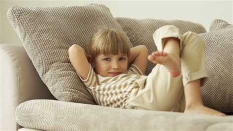 If you tell them to put their guns down, lay down on the floor, they'll do that, won't they? Little Girl Lying On Sofa Stock Footage Video (100% ...