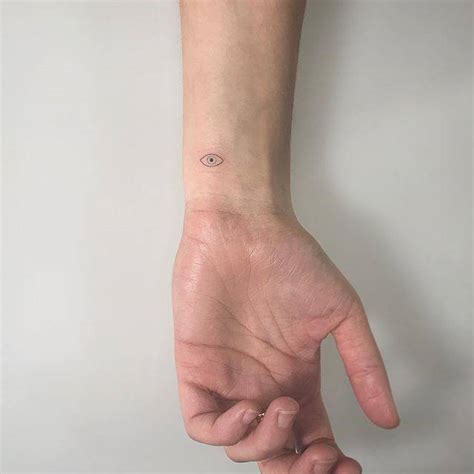 Evil eye tattoo on the wrist.