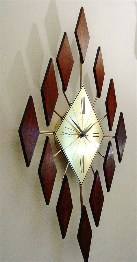 This coffin clock, model 557, seems to be strongly influenced by the emerging suburban dark wood themes of the late 1960s and early 70s. Starburst Clock of Diamonds Mid Century Modern Sunburst ...